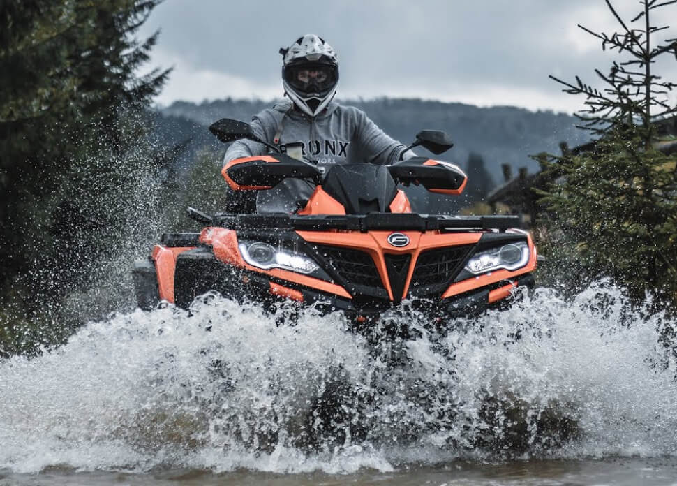 motorcyclist driving in the water