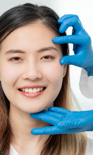 cosmetic surgeon examining a patients face