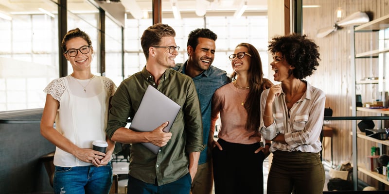 a group of marketing and sales professionals walking together and smiling