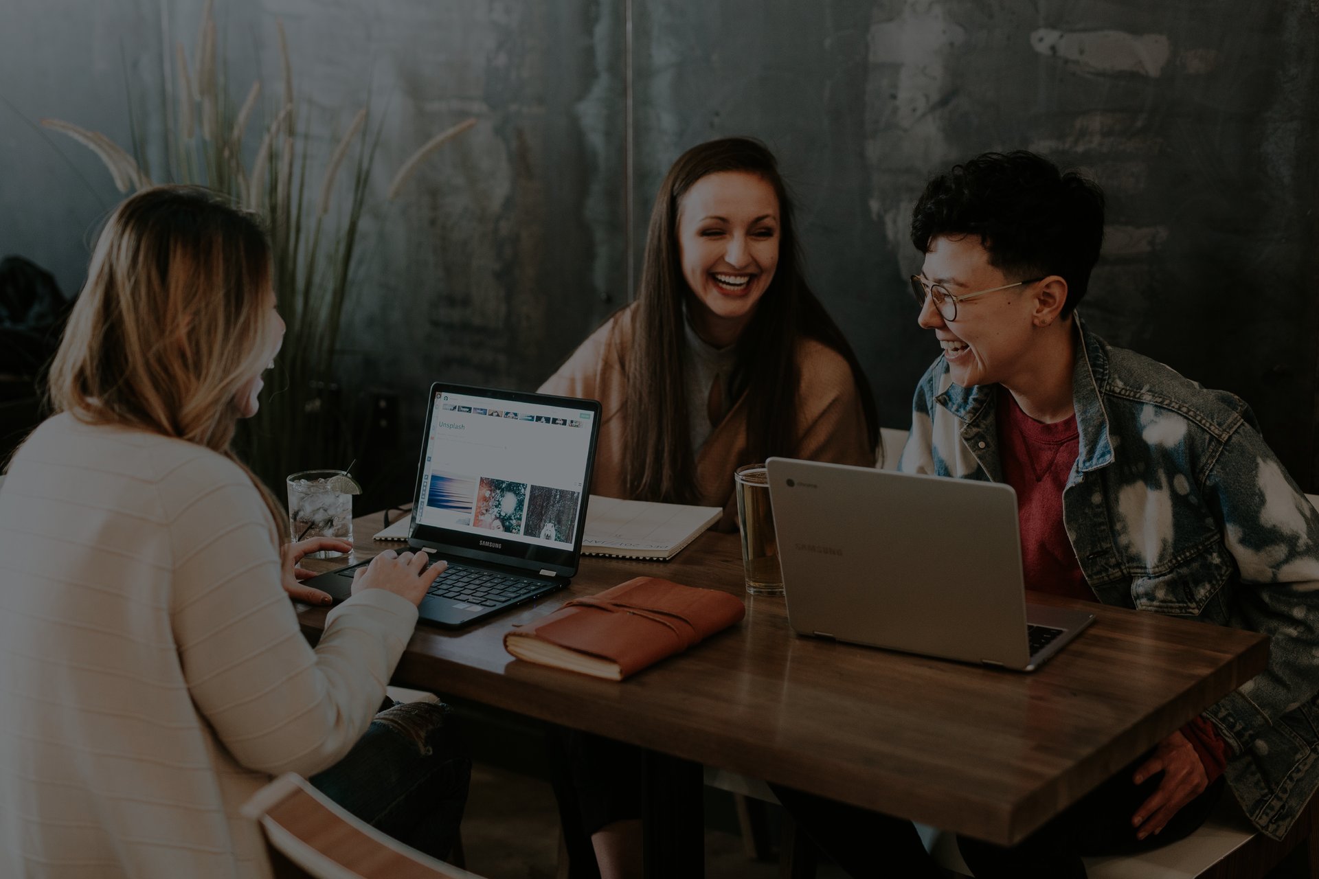 Three employees working and laughing
