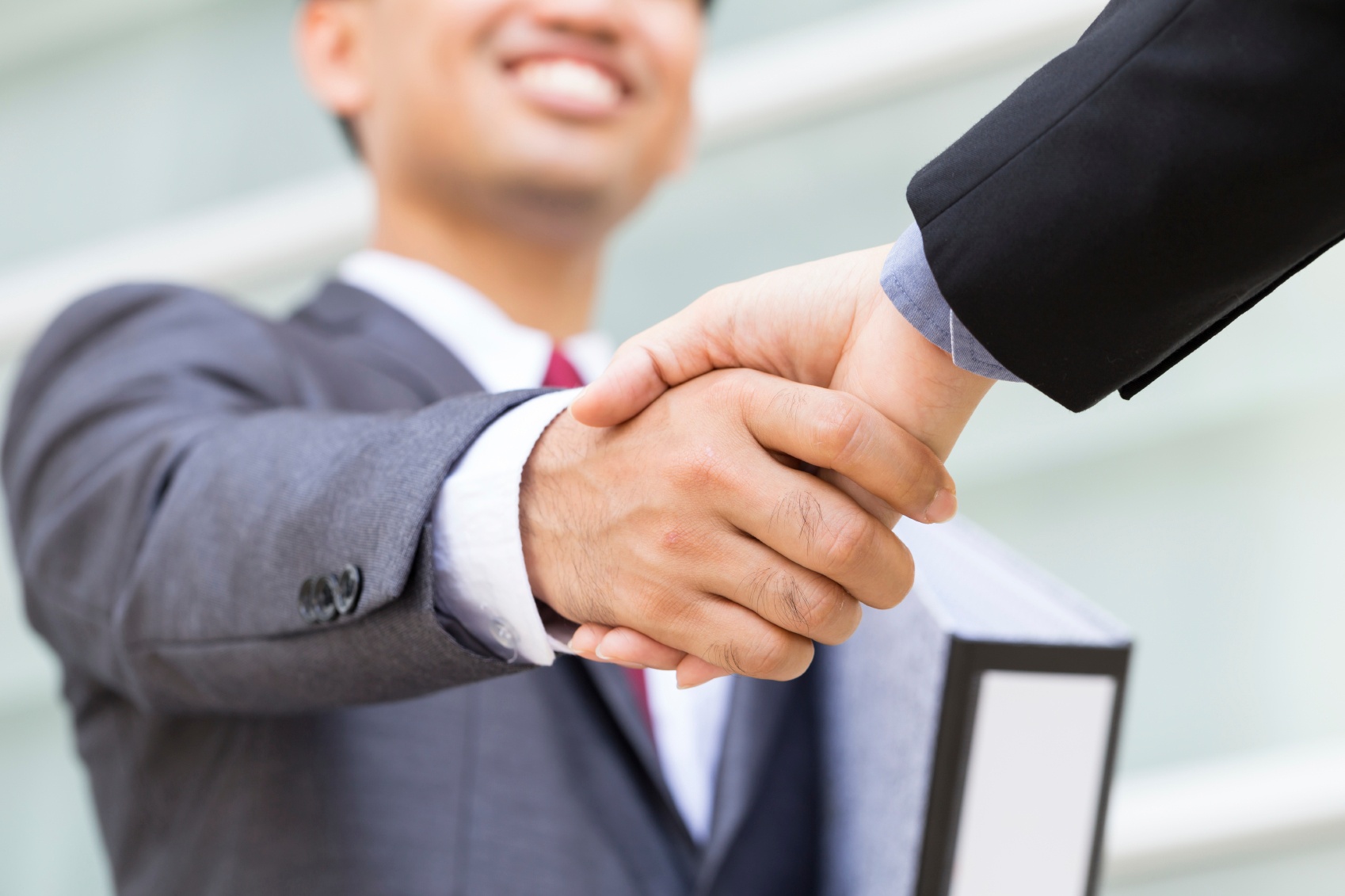 Photo of two businessmen shaking hands