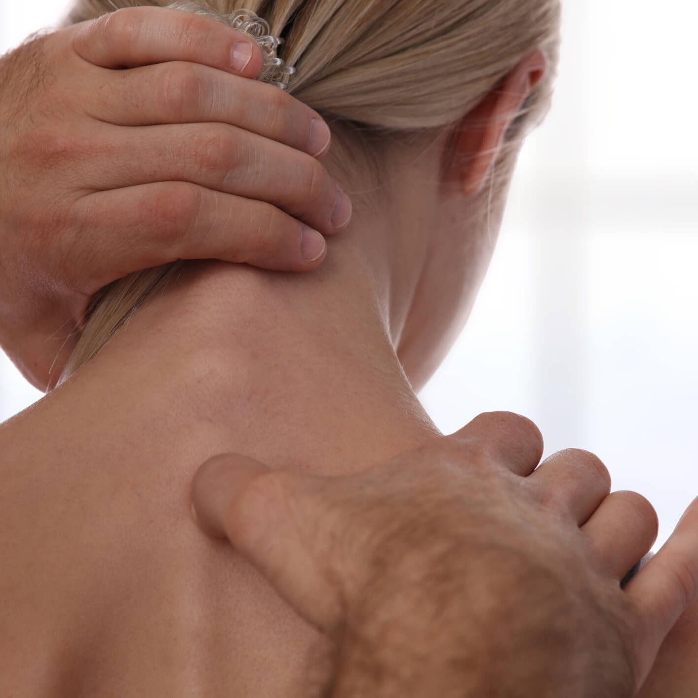 Woman receiving spine adjustment near neck