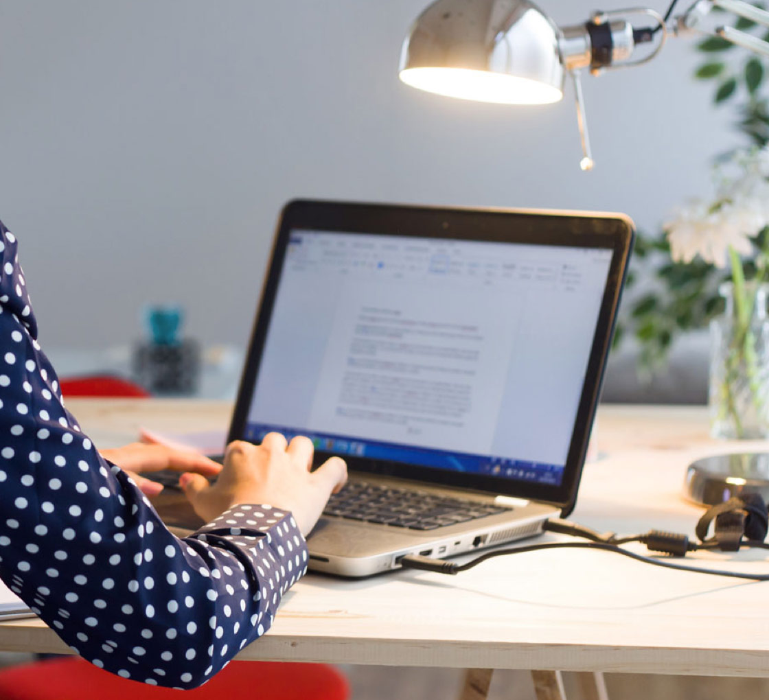 Woman typing on laptop computer
