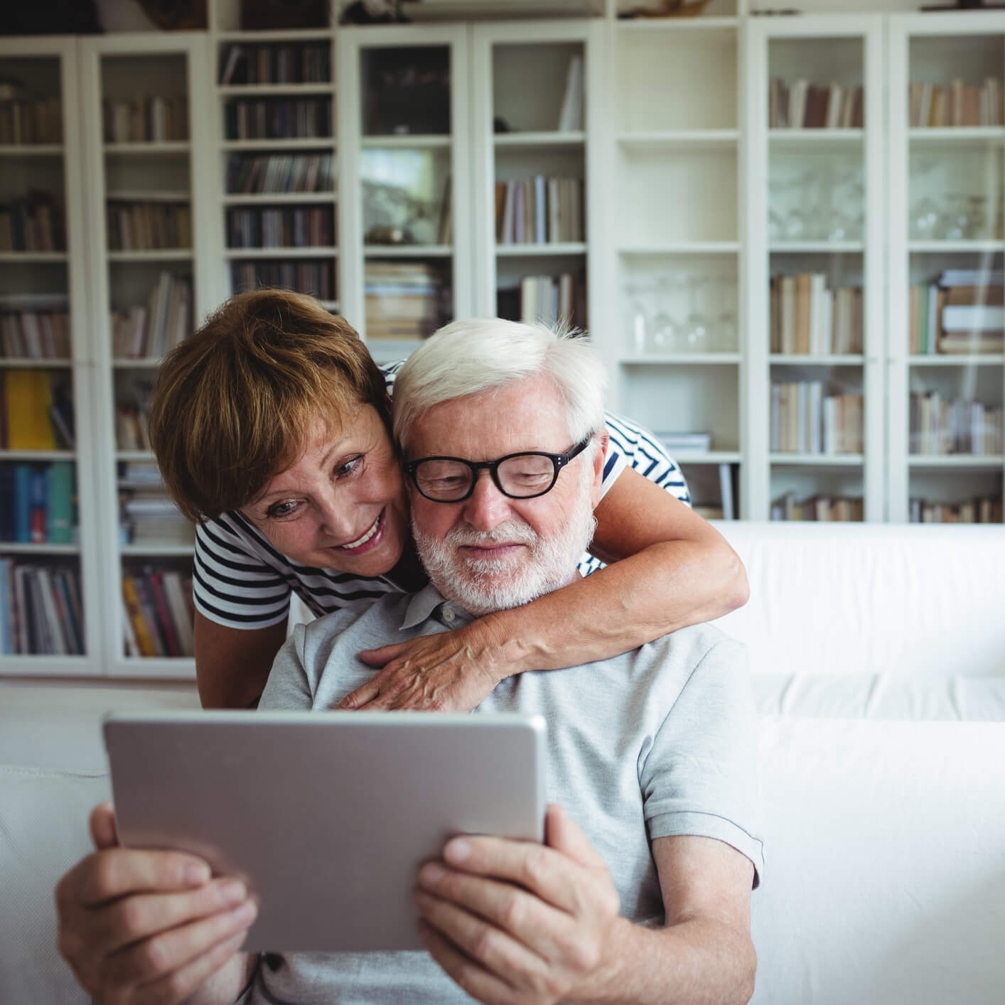 Couple looking at options for senior living on tablet
